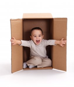 boy sitting inside cardboard box EASTLINES 